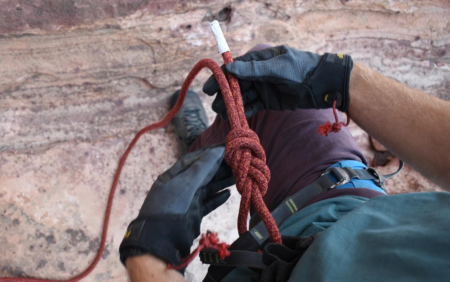 Climber tied in with a figure 8 follow-through knot through both hardpoints and with 6 inches of tail